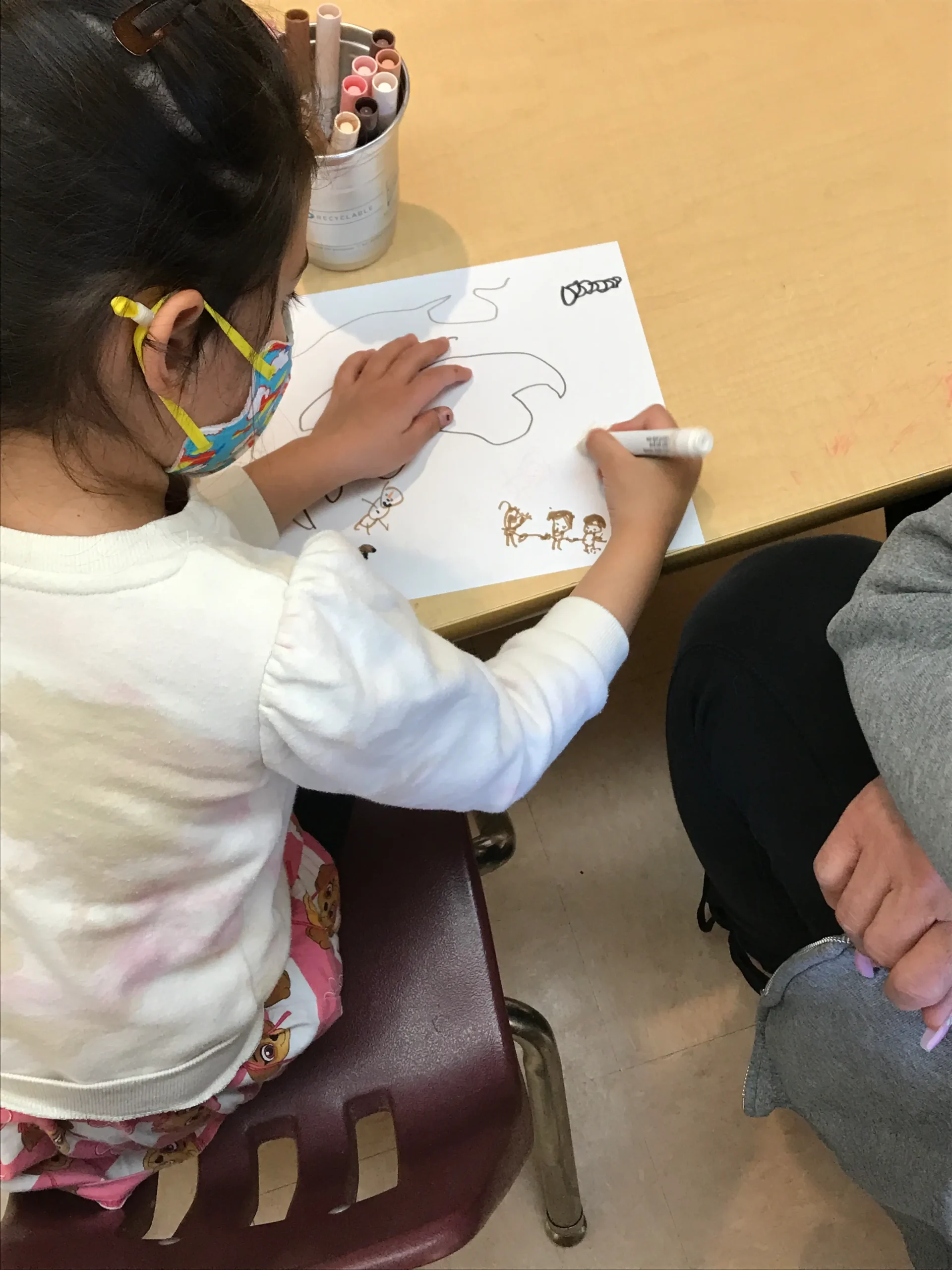 A four-year-old arranges the furnishings of the dollhouse at the Santa Fe Children's Museum.