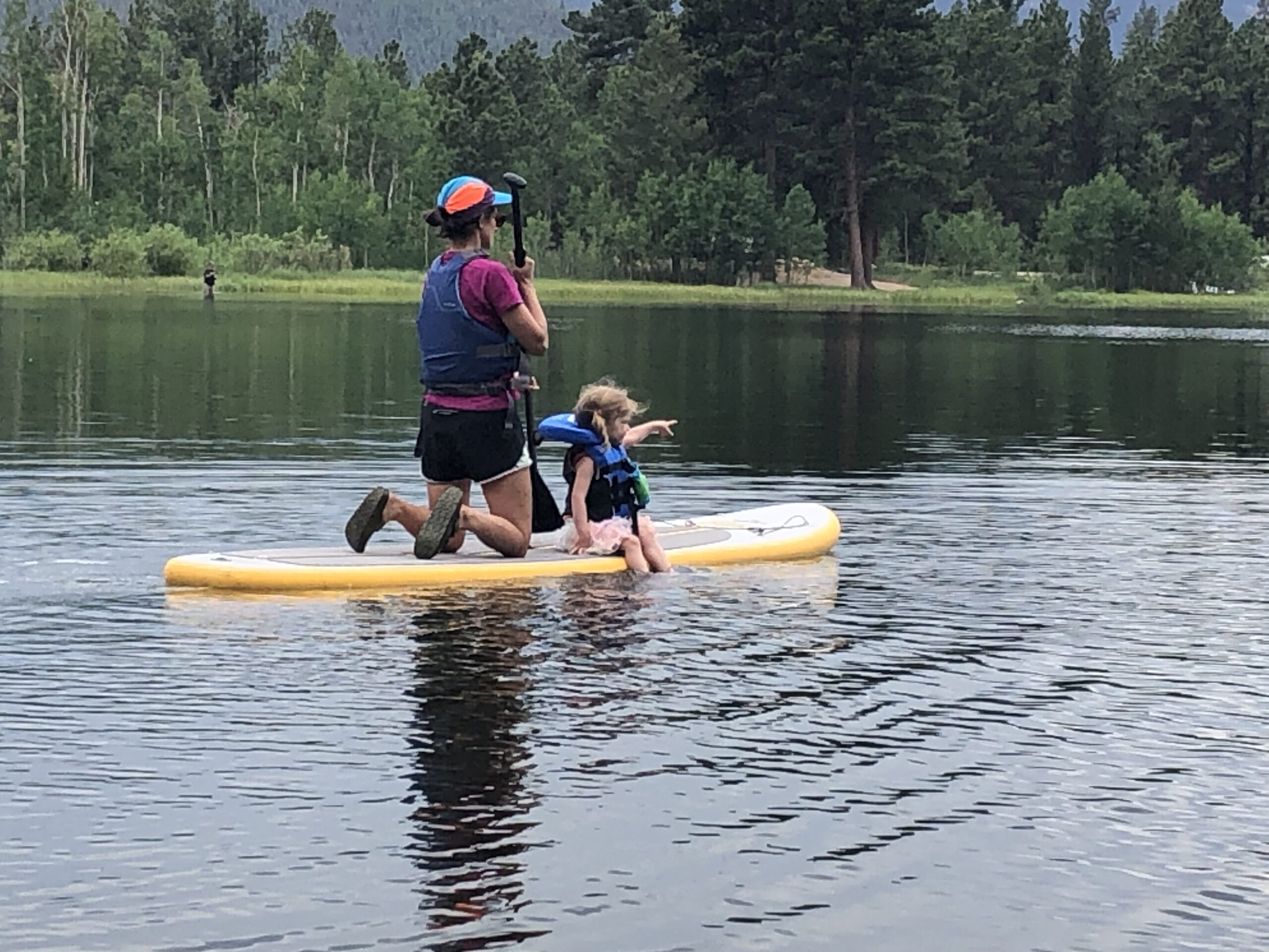 mother & daughter paddle boarding Mother and daughter paddleboarding