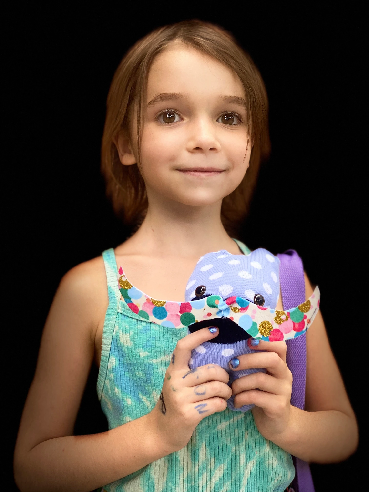artwork from young boy holding his art of a dog