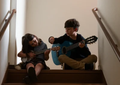 Calvin and Alma playing music on the stairs