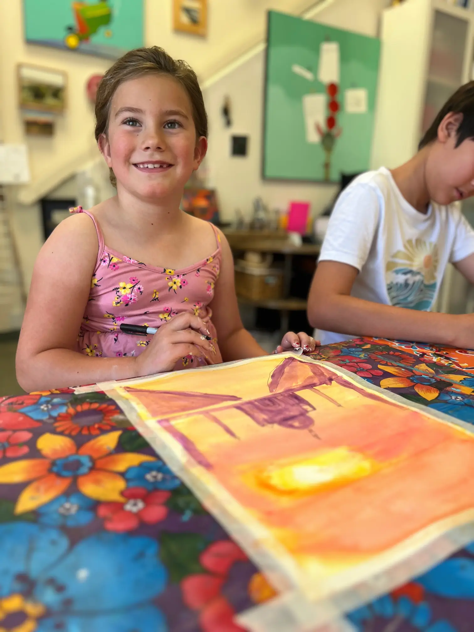 student smiling while painting