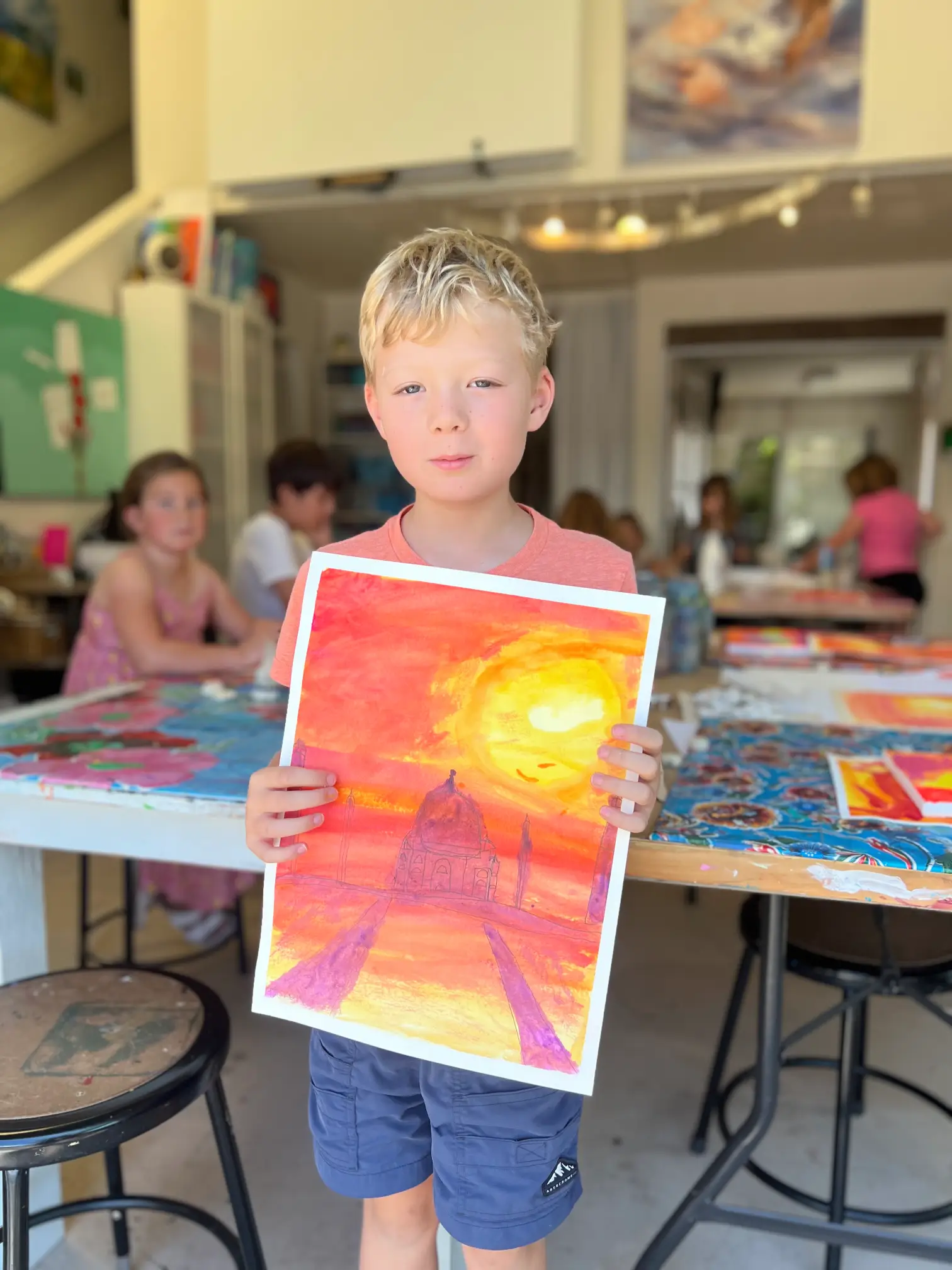 student shows off artwork