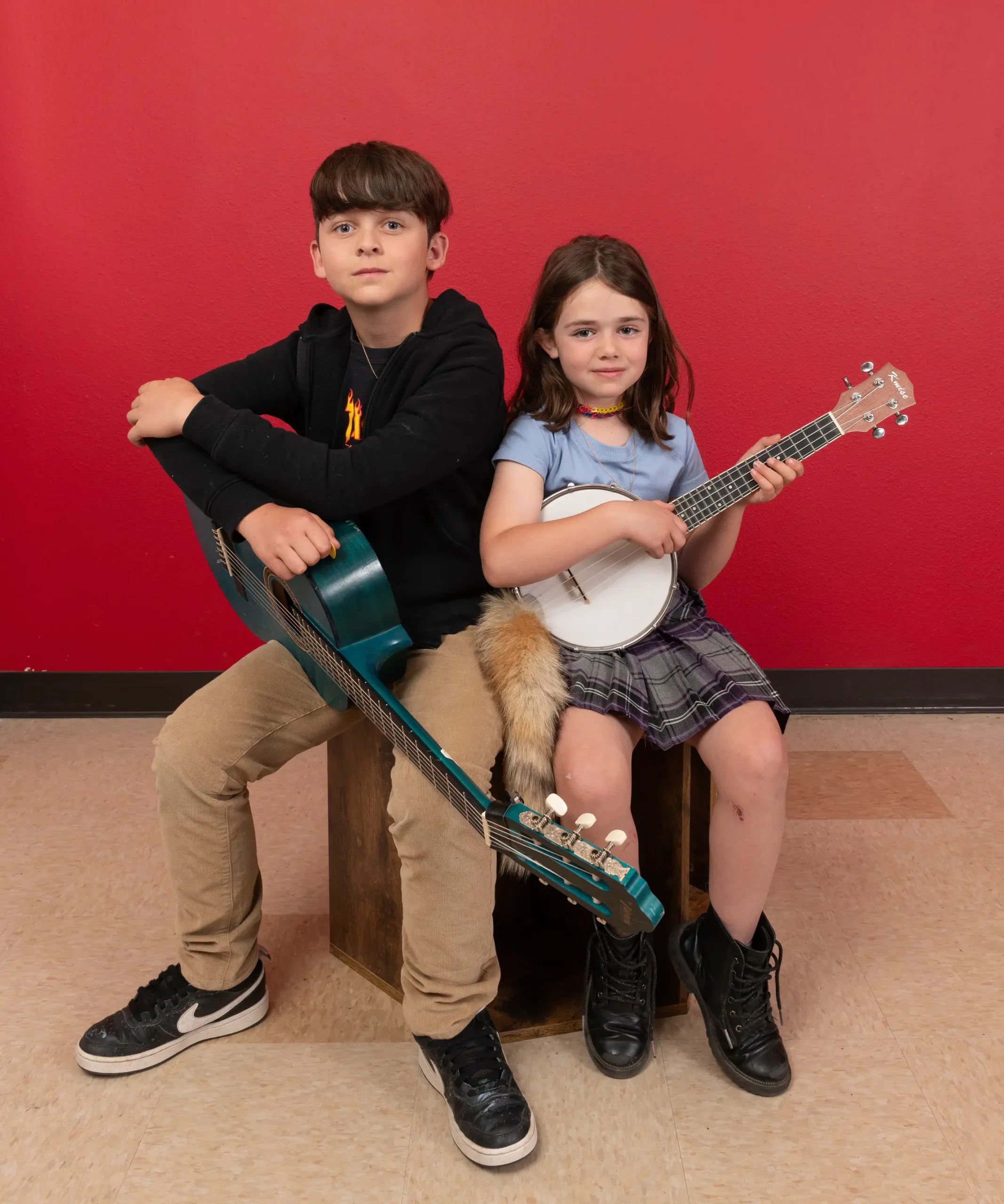 Brother and sister holding their instruments
