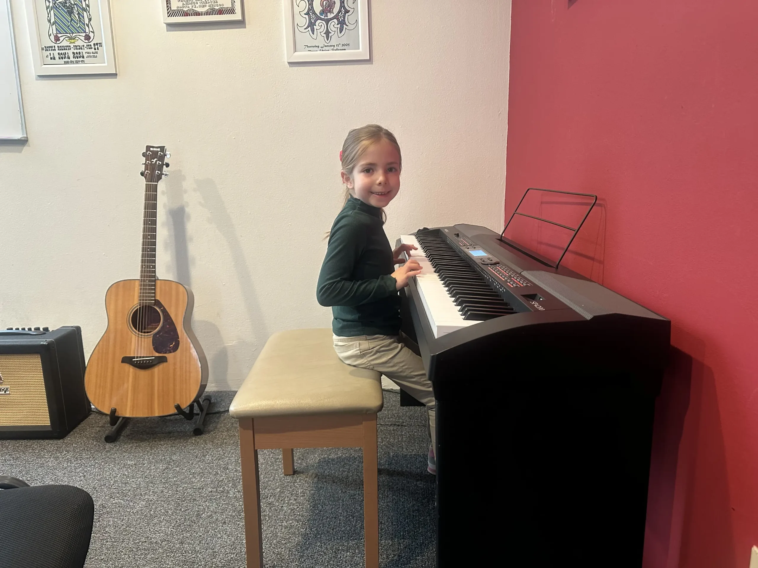 Courtesy photo: Aviva at her very first piano lesson at The Candyman Strings & Things—small hands on the keys, beginning a beautiful musical journey.